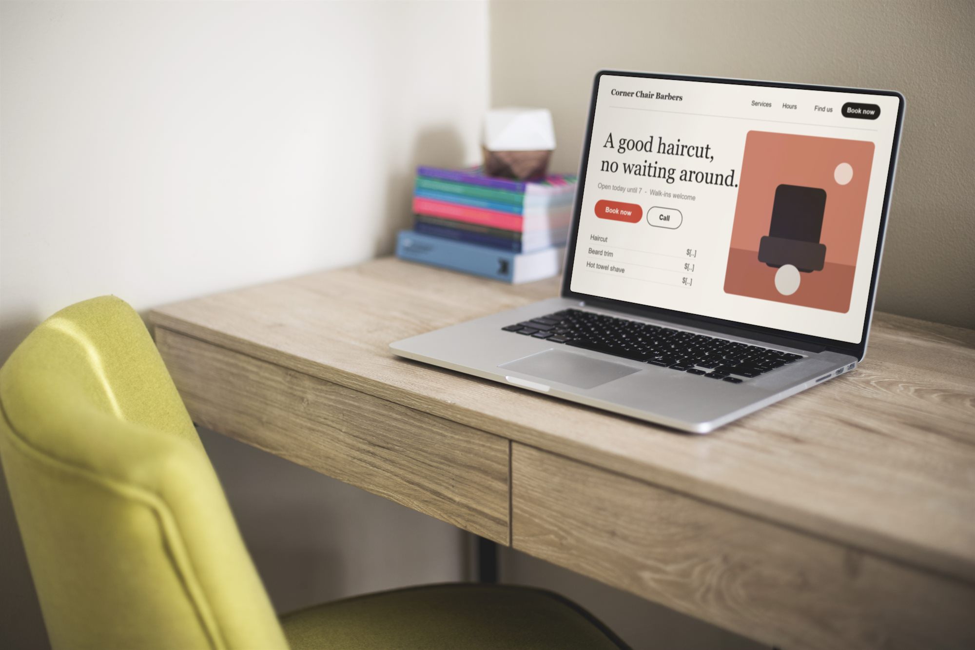 A laptop on a wooden desk showing a sample barber website